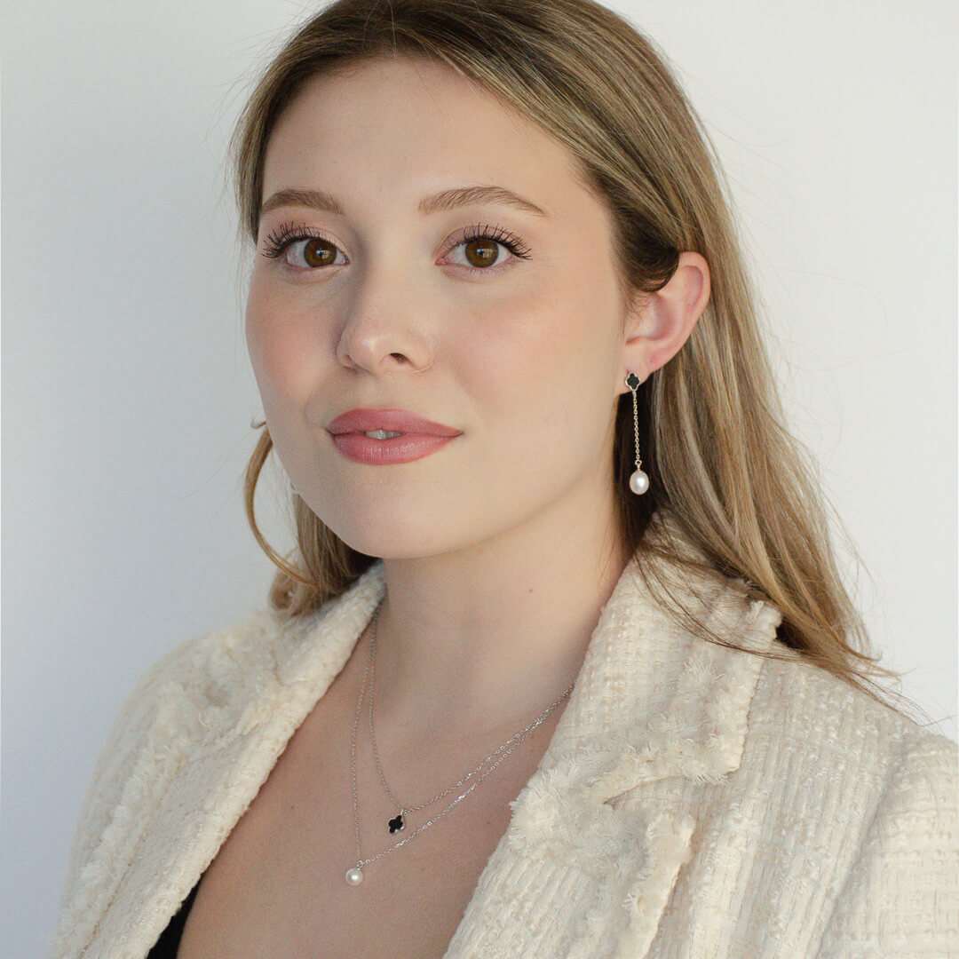 woman wearing sterling silver clover & pearl necklace