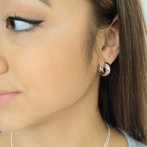 woman wearing sterling silver rhodium plated bubble hoop earrings