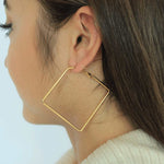 Load image into Gallery viewer, woman wearing stainless steel 18k gold plated square hoop earringsstainless steel 18k gold plated square hoop earrings 
