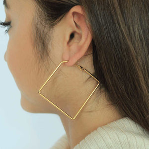 woman wearing stainless steel 18k gold plated square hoop earringsstainless steel 18k gold plated square hoop earrings 