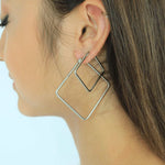 Load image into Gallery viewer, woman wearing stainless steel square hoop earrings 
